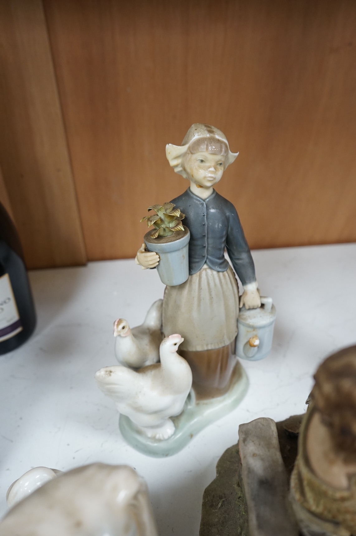 A collection of pottery and porcelain to include a Hayle model of a seal, Lladro figures and a pair of Fairy cabinet plates, largest 27cm wide